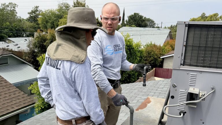 Cold Cloud technicians servicing a rooftop package unit