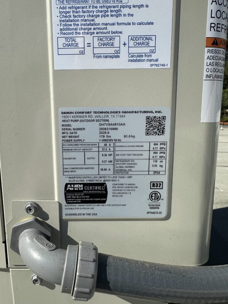 Checking equipment specifications is part of a winter HVAC maintenance checklist Equipment data plate checked during a winter furnace inspection