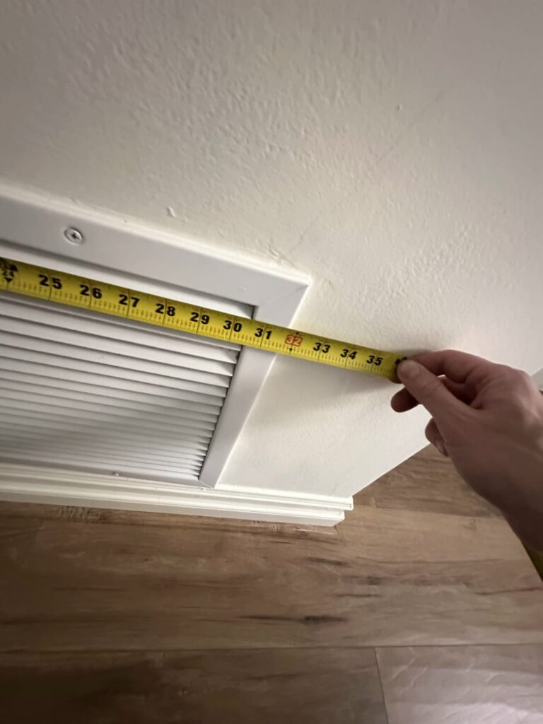 Clearing and checking vents improves airflow before the cooling season Air vent register being checked as part of a spring AC maintenance checklist