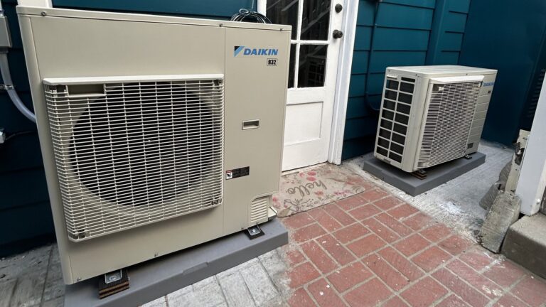 Two new Daikin heat pump outdoor units installed in a Los Angeles courtyard