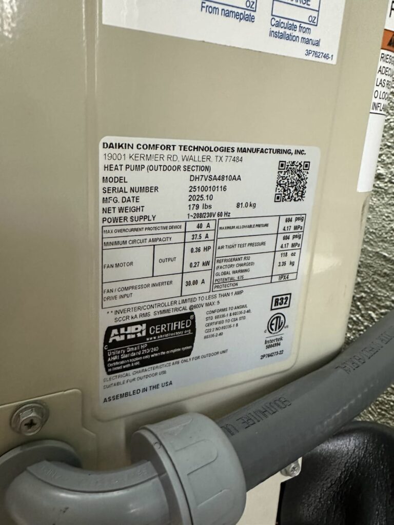 Checking system specifications during routine heat pump or AC maintenance HVAC system data plate showing model and efficiency specifications