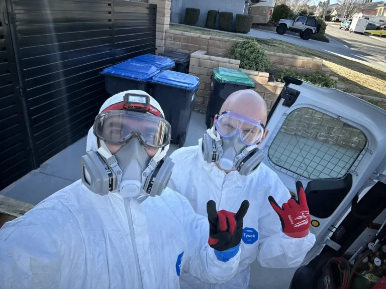 Cold Cloud technicians in protective suits and respirators ready for an attic job