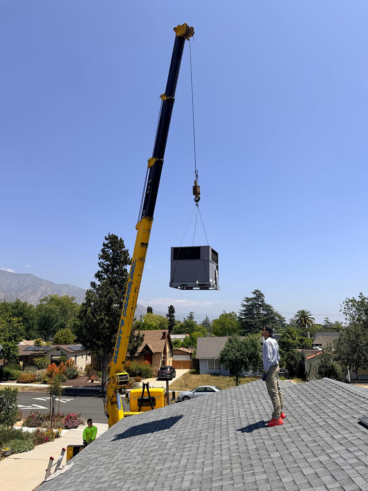 Crane lift for Daikin package unit installation on Pasadena rooftop