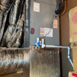 Attic ductwork wrapped in insulation, a common check when air isn't reaching certain vents