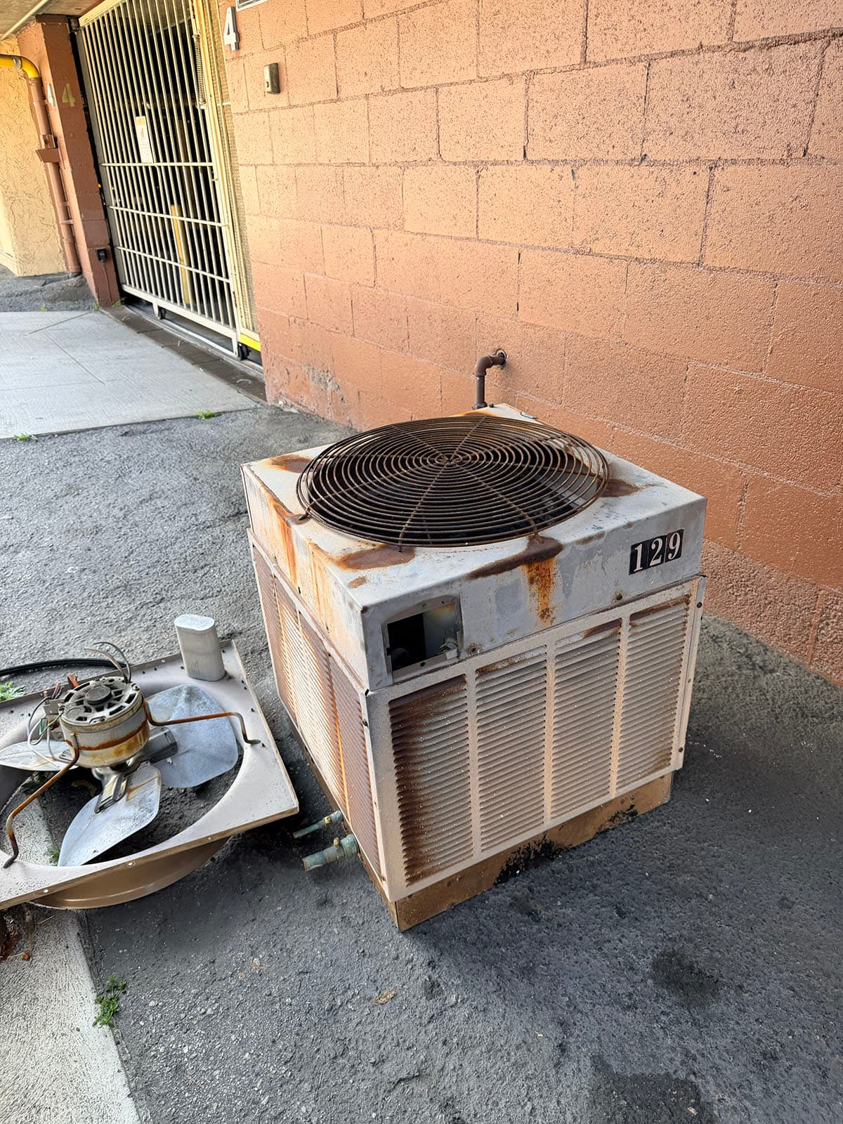 Old outdoor condenser before Goodman heat pump changeout in Glendale