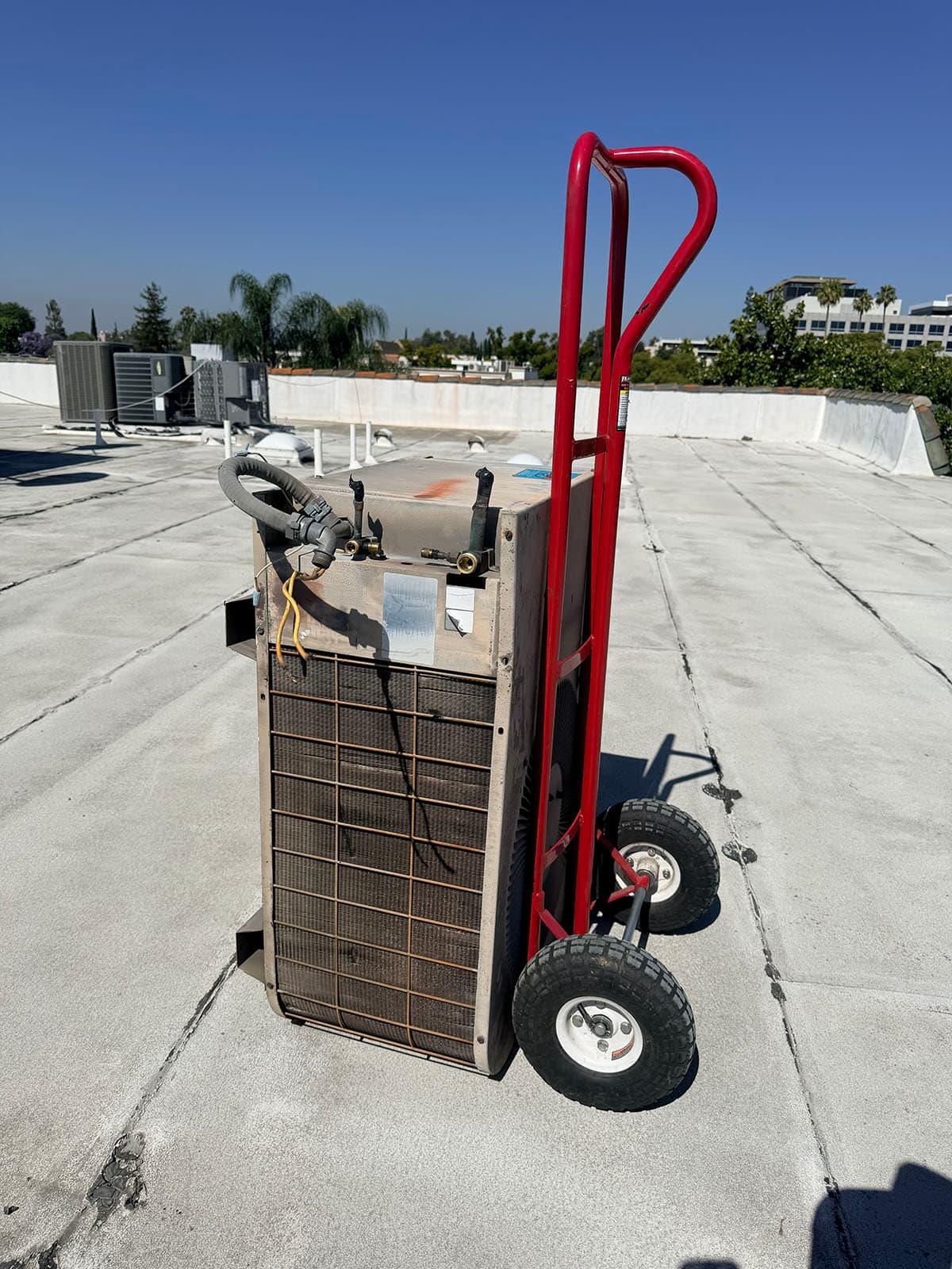 Old rooftop condenser removed for Goodman heat pump installation