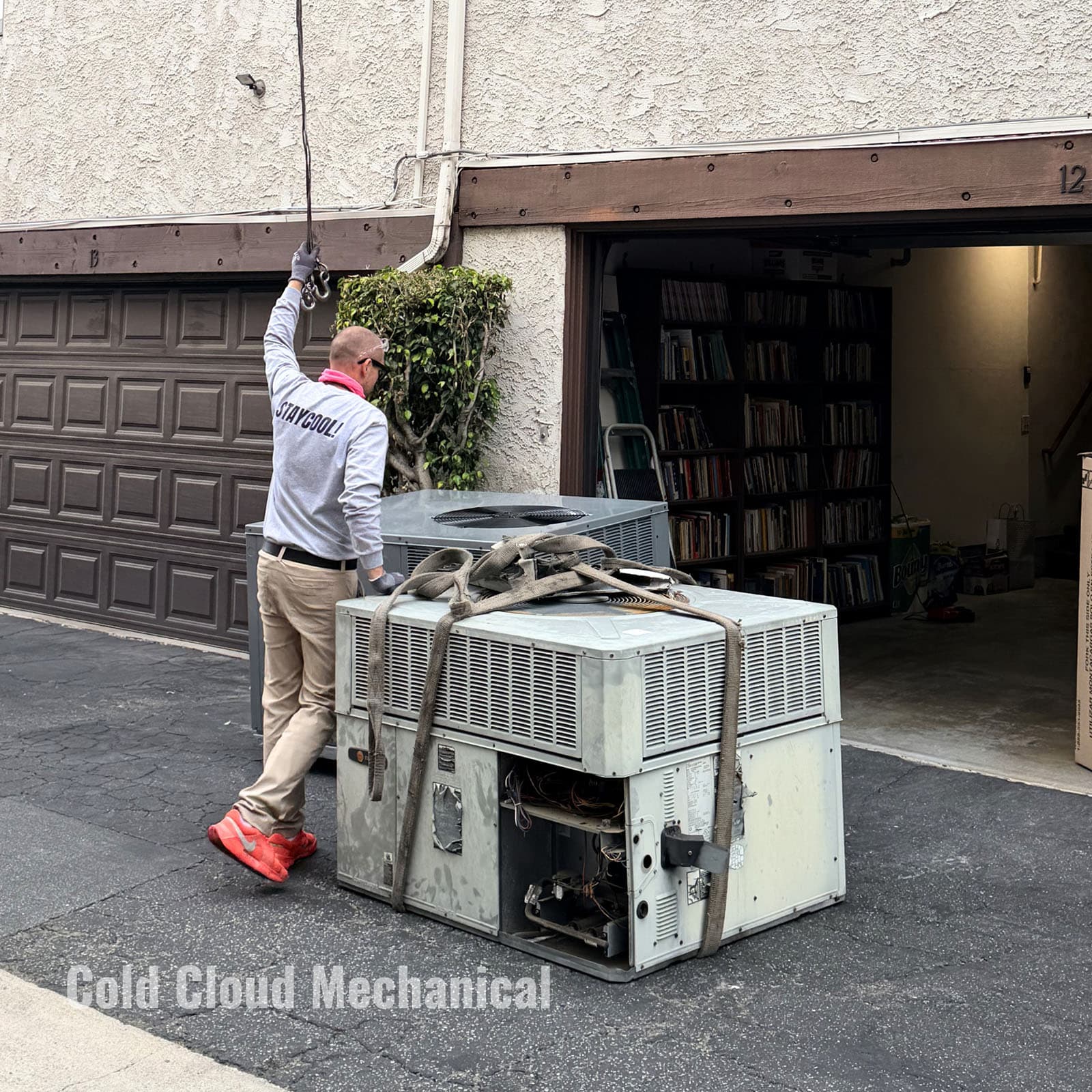 Technician disconnecting old rooftop HVAC unit in Pasadena