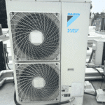 Daikin outdoor HVAC condenser unit installed on a residential wall by COLD CLOUD