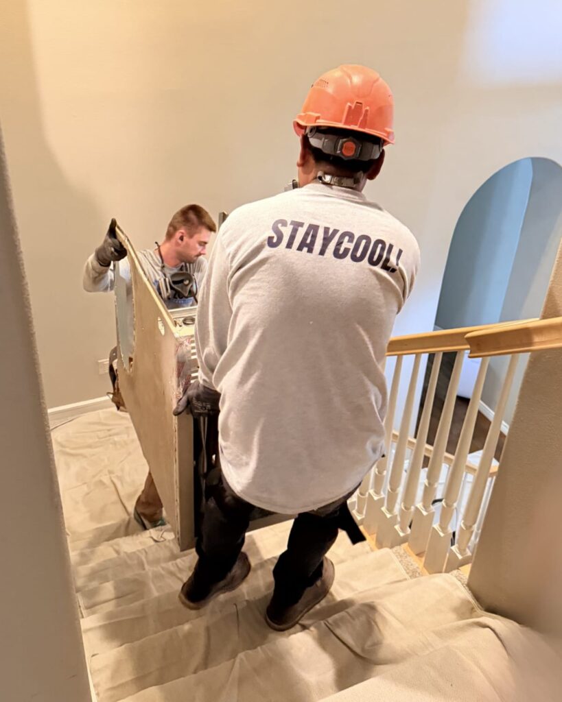 HVAC technician reviewing Manual J load calculation diagrams on a laptop