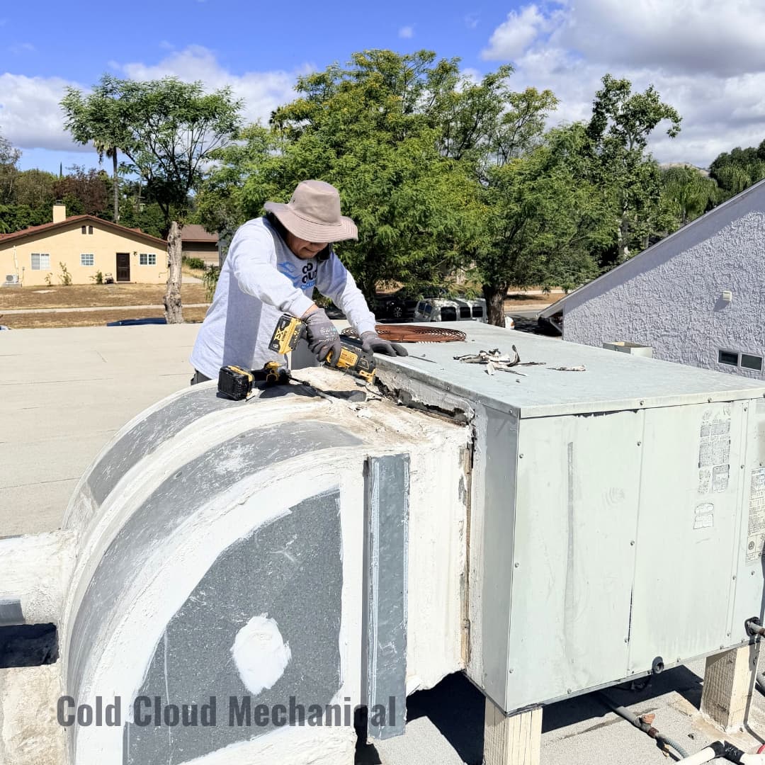Technician removing old rooftop package unit panels in Granada Hills