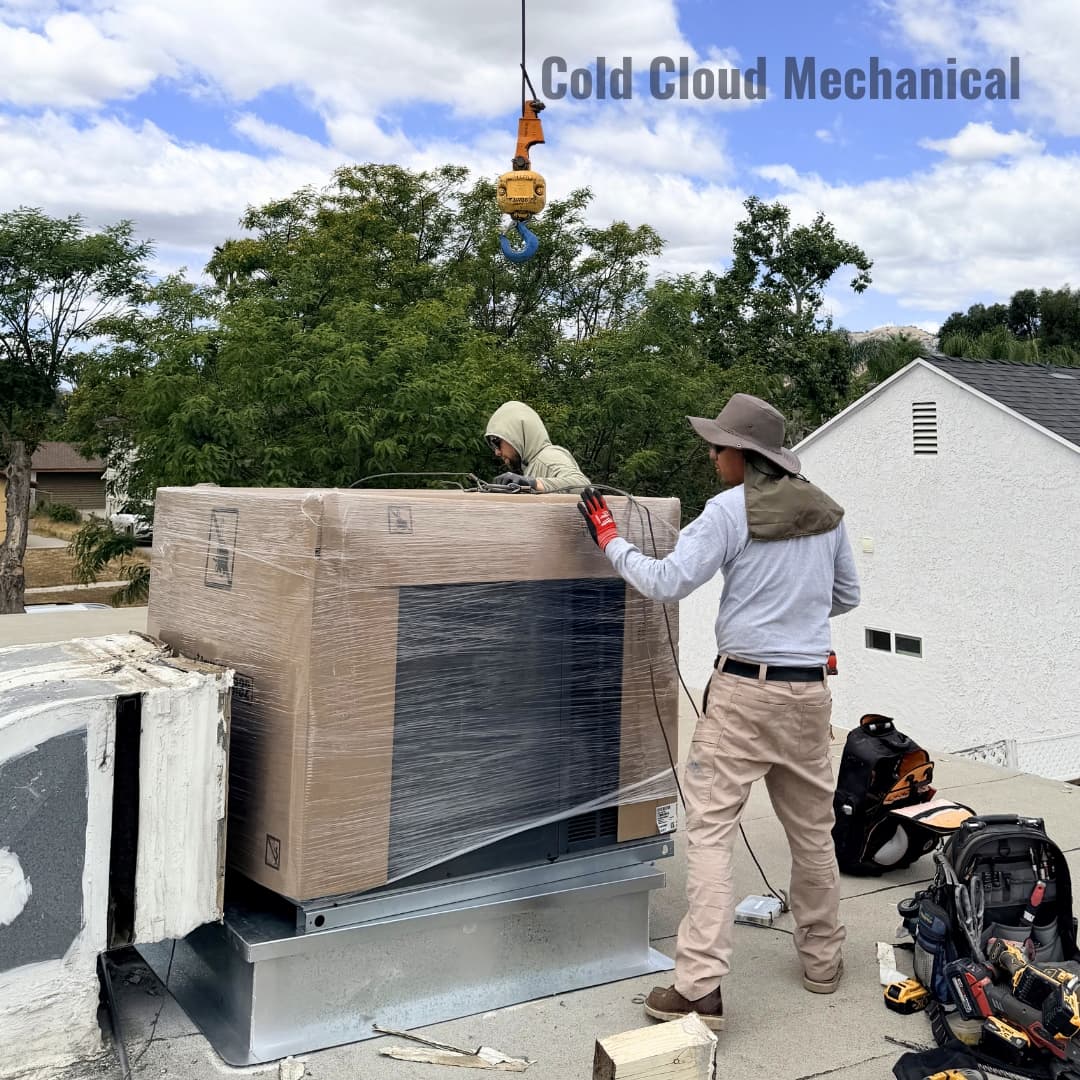 Technicians setting Goodman package unit on curb adapter