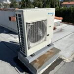 Outdoor AC condenser unit installed on rooftop or concrete pad