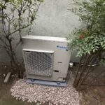 4-ton outdoor HVAC condenser unit on concrete pad at residential property