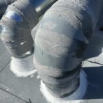 Insulated rooftop ductwork elbows sealed with mastic coating