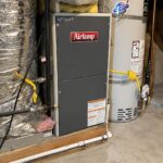 Gas furnace and water heater in a basement mechanical room