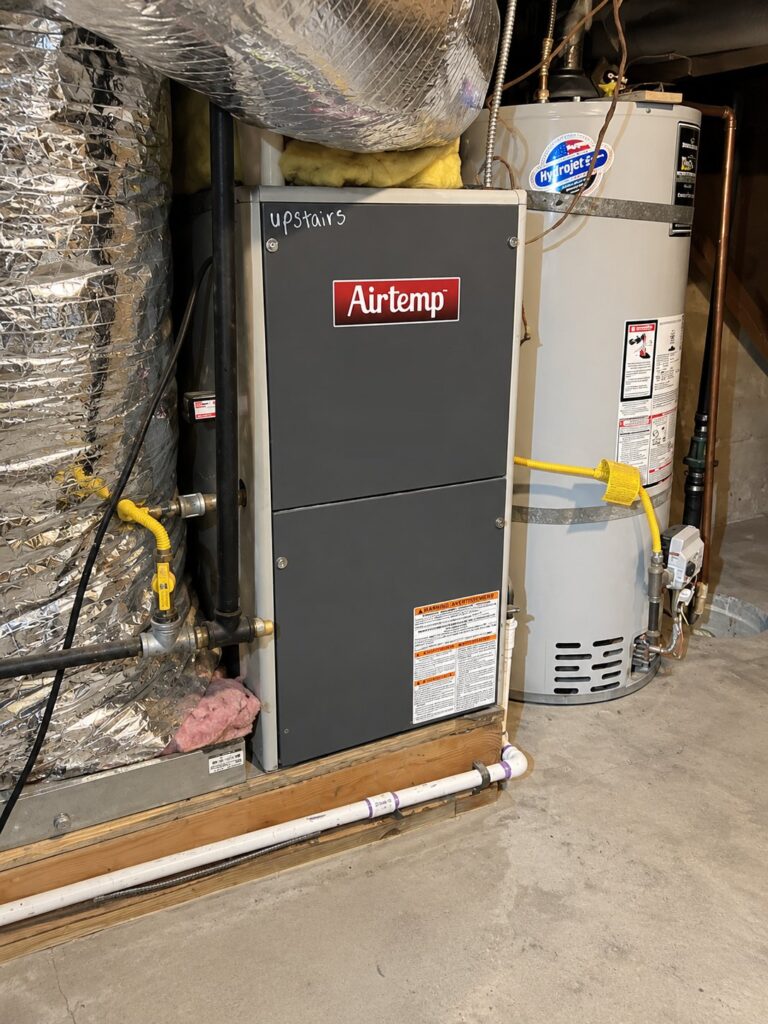 Gas furnace and water heater in a basement mechanical room