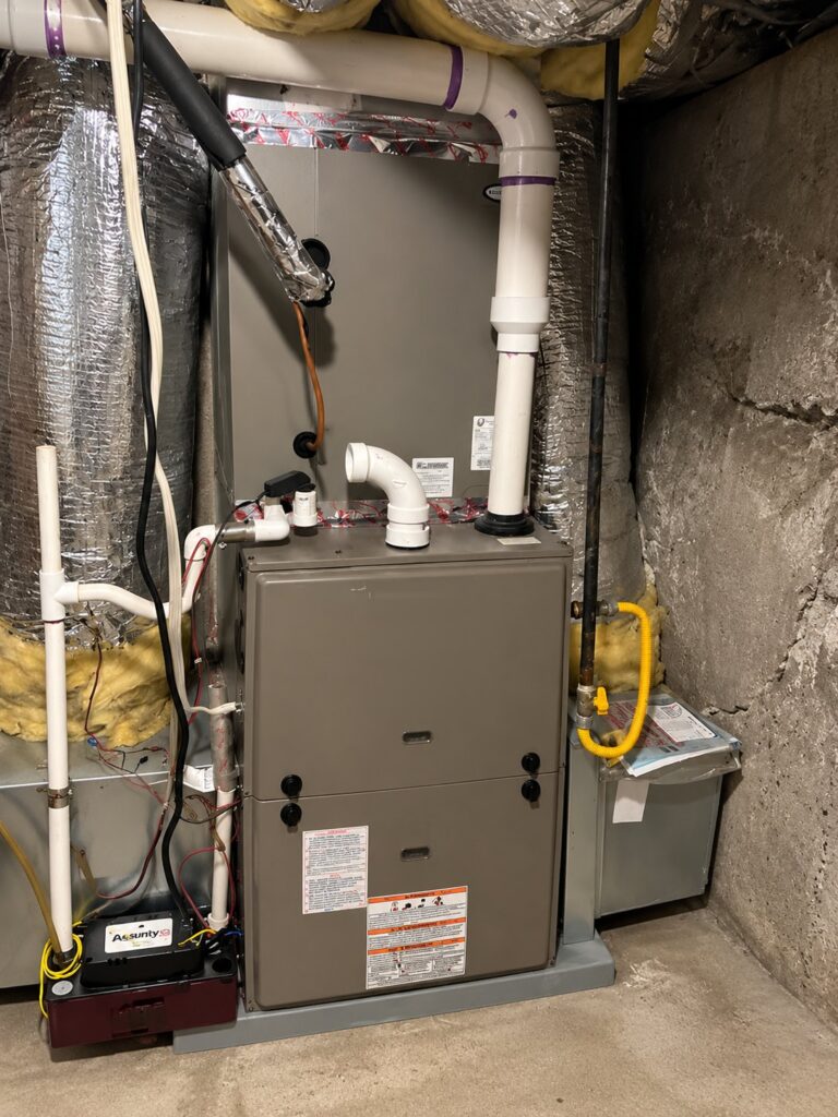 High-efficiency gas furnace installed in a basement utility room