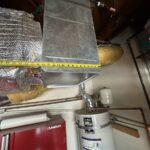 Insulated HVAC ductwork in garage ceiling ahead of dehumidifier tie-in