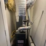 Residential gas furnace inside home mechanical closet