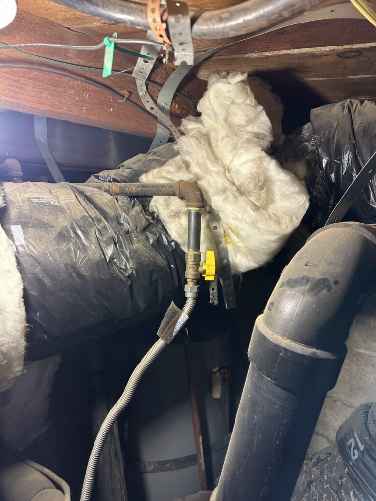 Insulated attic ductwork showing signs of moisture damage