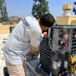 Outdoor AC condenser unit on concrete pad ready for scheduled tune-up
