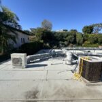 Rooftop HVAC condenser unit serviced under clear LA sky