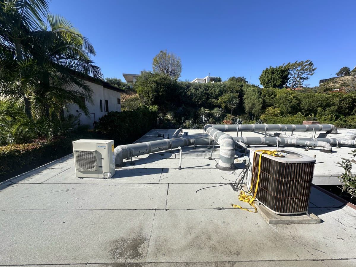 Rooftop AC maintenance visit in Los Angeles climate Rooftop HVAC condenser unit serviced under clear LA sky